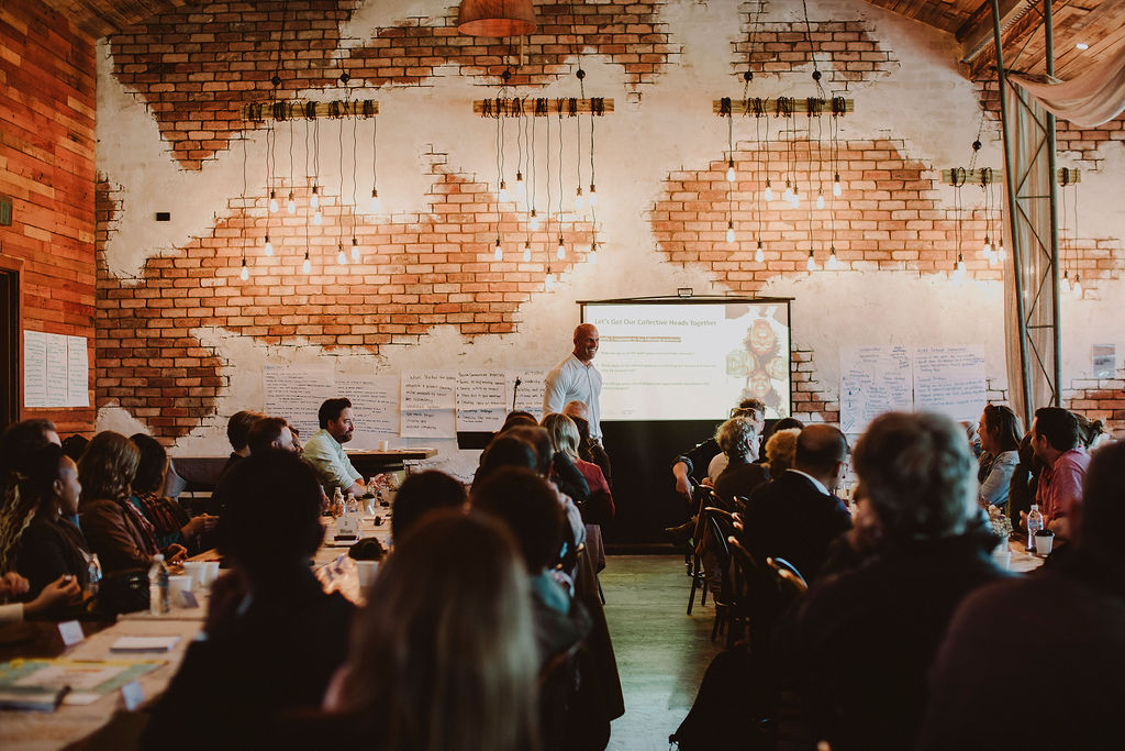 Ian Williams facilitating a workshop in a full room